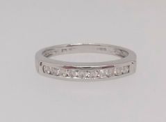 A 9ct white gold and diamond channel set half band eternity ring, with ten round cut