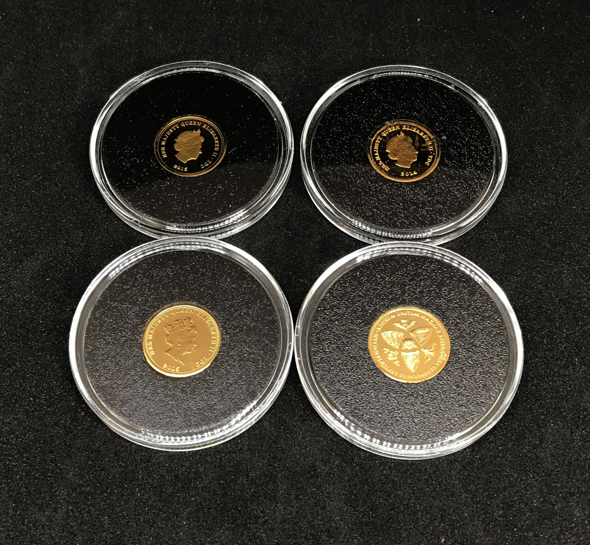 Jubilee Mint, four QEII commemorative coins including centenary of WWI in 9ct gold.
