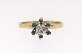 An 18ct emerald and diamond cluster ring, size O.