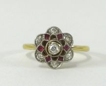 An 18ct ruby and diamond cluster ring of flower design, size L.