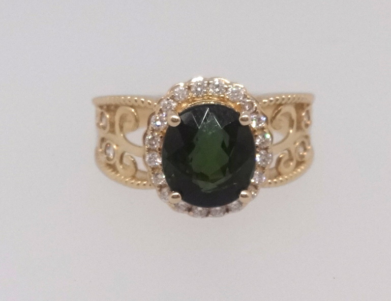A 14k yellow gold and diamond ring set with an oval cut green tourmaline approx 2.95ct, diamonds