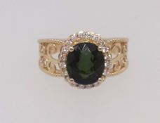 A 14k yellow gold and diamond ring set with an oval cut green tourmaline approx 2.95ct, diamonds