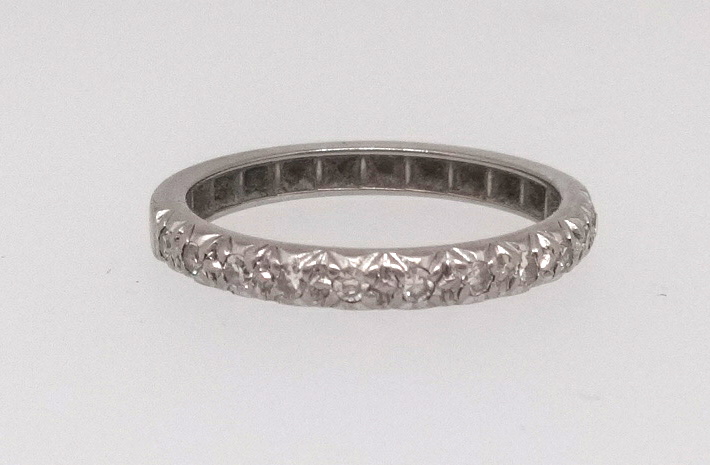 A white gold half band diamond set eternity ring, size Q.