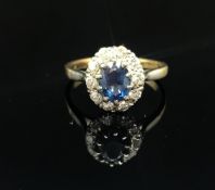 An 18ct diamond and sapphire cluster ring, size P.
