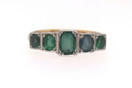An 18ct five stone emerald set ring, size P.