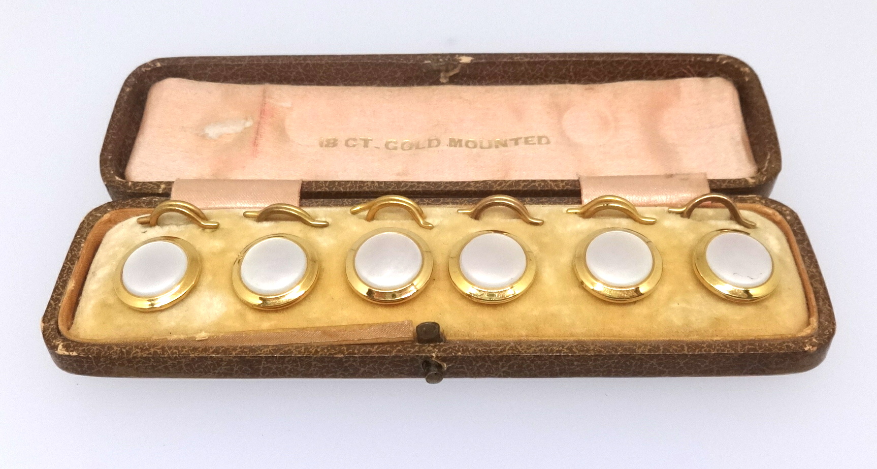 A set of six 18ct gold and mother of pearl shirt dress buttons in original fitted box.