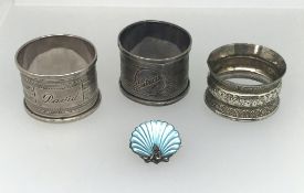 Three silver napkin rings and a silver and enamel pixie brooch (4), total weight approx 60gms.