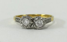 An 18ct two stone diamond ring, size N.