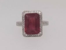 A 14k white gold and diamond ring set with an emerald cut ruby approx 7ct diamonds, approx 0.30ct