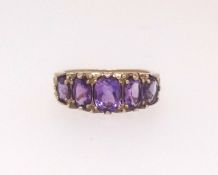A 9ct amethyst five stone ring, size O.