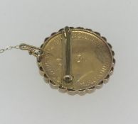 A Geo III 1915 gold sovereign in gold brooch mount.