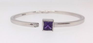 A 9ct amethyst and diamond contemporary styled bangle.