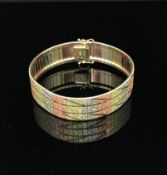 A 9ct multi coloured gold wide bracelet, approx 21gms.