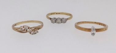 A 18ct and platinum three stone diamond ring, a 9ct five stone diamond ring and another (3),