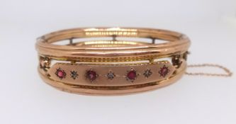 An antique 9ct bangle set with rubies and diamonds, approx 11gms.