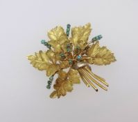 An 18ct flower brooch set with turquoise, approx 12.3gms.