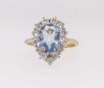 An 18ct aqua marine and diamond cluster ring, size N.