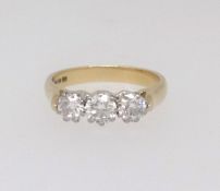 A good 18ct three stone diamond ring together with a copy of the insurance valuation indicating