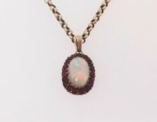 A ruby and opal cluster pendant set on a yellow metal chain, unmarked.