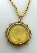 Victoria, 1857 shield back sovereign set in a pendant mount on a gilt metal chain.