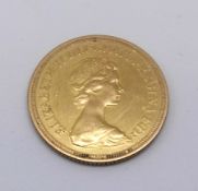 A QEII, a 1976 gold sovereign.