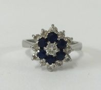 An 18ct sapphire and diamond cluster ring, size N.
