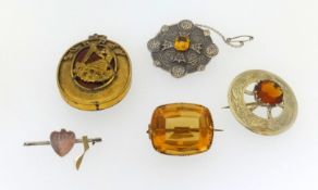 Two Scottish brooches and a large citrine brooch in yellow metal together with a Surrey Freemasons