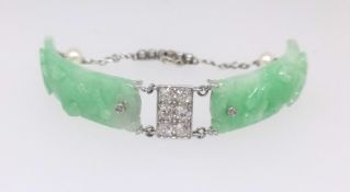 An 18ct white gold and platinum jade set bracelet set with two jade panels, pearls and small