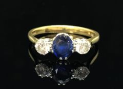 A 18ct sapphire and diamond three stone ring, size N.