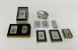 A collection of nine lighters including Zippo, some with Submarine crest including USS Charr,