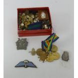 A collection of military cap badges, others and various WWI Victory medals.