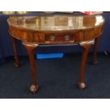 A walnut side table of Georgian design fitted with a single drawer on shaped