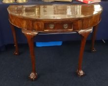 A walnut side table of Georgian design fitted with a single drawer on shaped