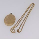 A 9ct gold locket marked GJ Ltd approx 14gms on a gilt chain.