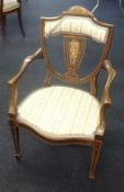 An Edwardian elbow chair with inlay decoration.