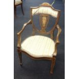 An Edwardian elbow chair with inlay decoration.