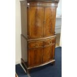 A Reprodux mahogany cocktail cabinet made by Bevan & Funnell Ltd with a light, glass shelves and