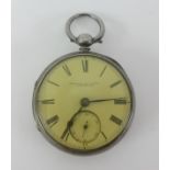 A silver open face pocket watch with key.