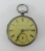 A silver open face pocket watch with key.