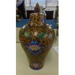 An oriental porcelain vase, baluster shaped, richly decorated with stylised flowers, with cover, six