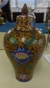 An oriental porcelain vase, baluster shaped, richly decorated with stylised flowers, with cover, six