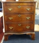 A small mahogany serpentine chest fitted with three drawers, width 61cm.