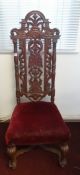 An antique carved high back chair.