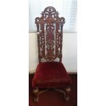 An antique carved high back chair.