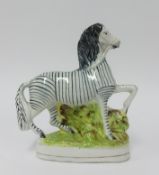 A Staffordshire style flat back figure of a Zebra, height 21cm.