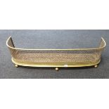 A Victorian pierced brass curbed fender, length approx 107cm.