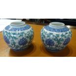 A pair of oriental porcelain squat vases, height 10cm