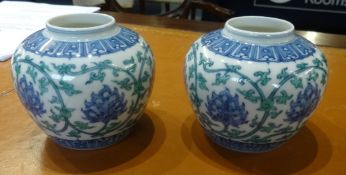 A pair of oriental porcelain squat vases, height 10cm