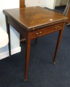 An Edwardian mahogany and cross banded envelope card table.