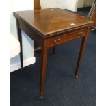 An Edwardian mahogany and cross banded envelope card table.